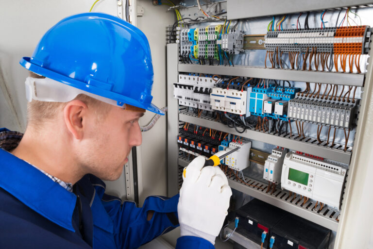 Male Electrician Examining Fusebox