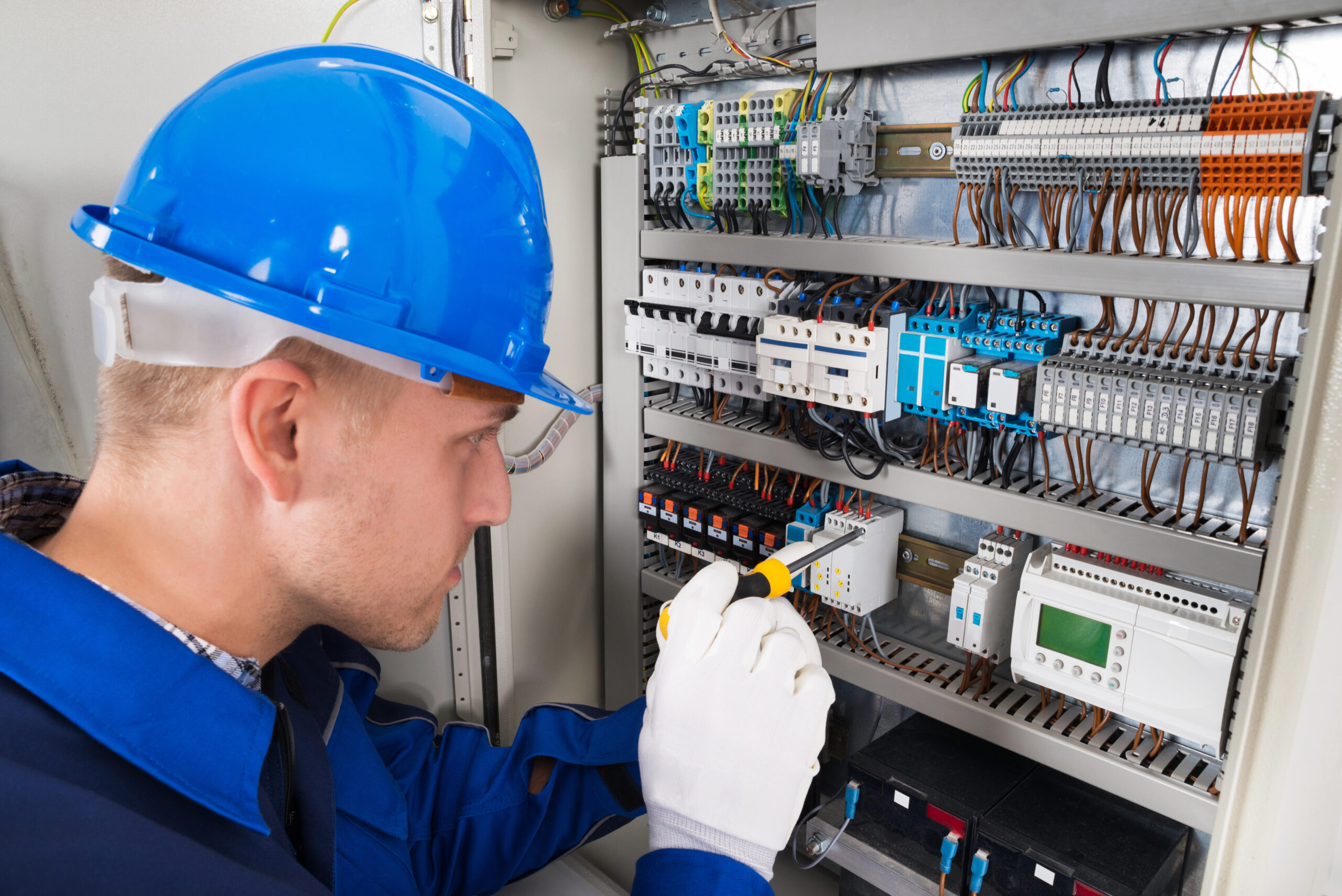Male Electrician Examining Fusebox